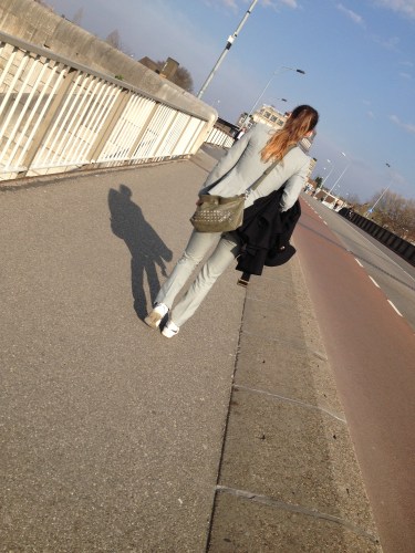 Jonge vrouw in stijlvol grijs. Ik vraag me af hoe mijn leven er uit zou zien als ik haar leeftijd zou hebben. Zou  ik andere keuzes maken?